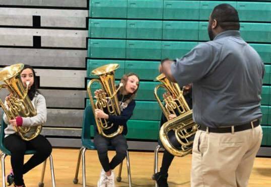 group holding tubas